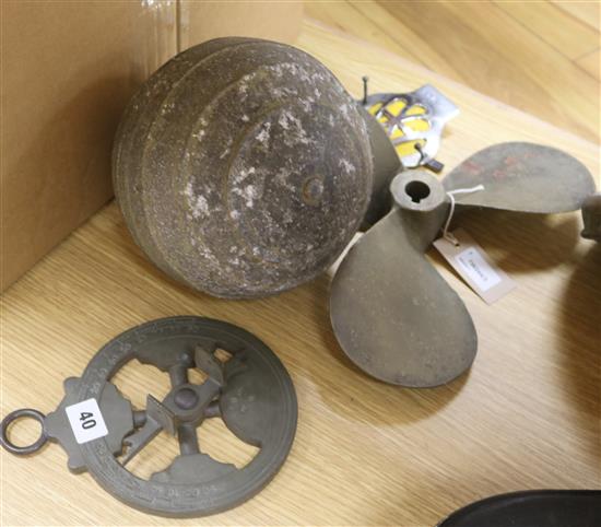A Rushmore Dynamo Works car headlamp, an AA badge, a bronze boat propeller, a metal float and another item